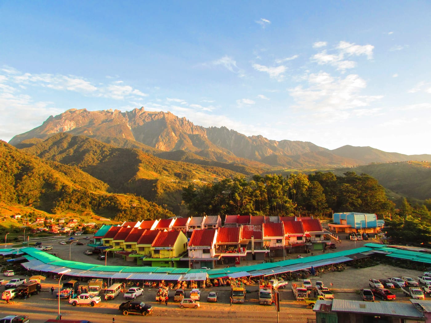 Mount Kinabalu rising above the green landscape of Kundasang